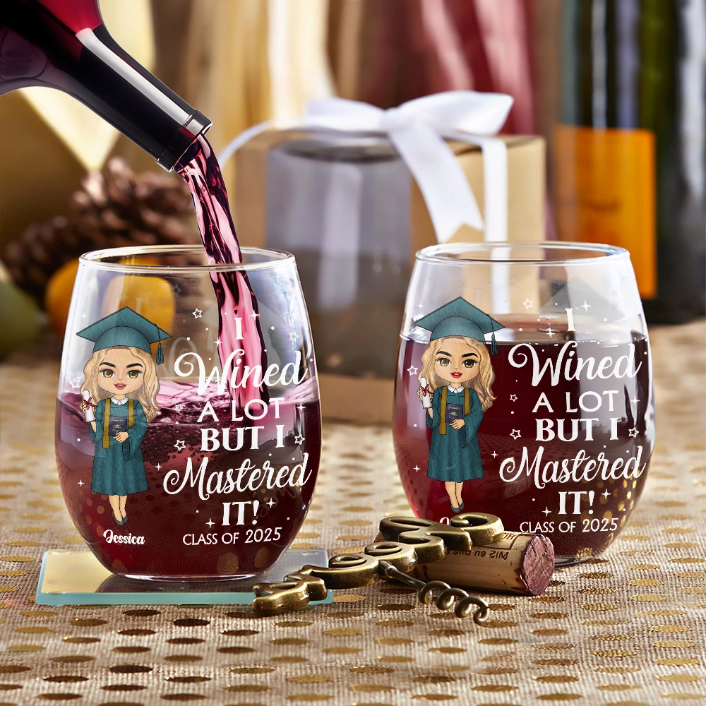 Personalized "I Wined a Lot But I Mastered It" graduation wine glasses, filled with wine, graduation gift.